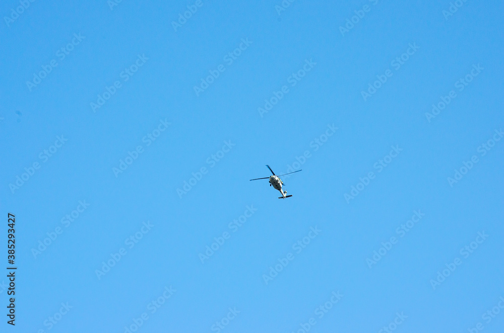 helicopter flying on blue sky helicopter flying on blue sky