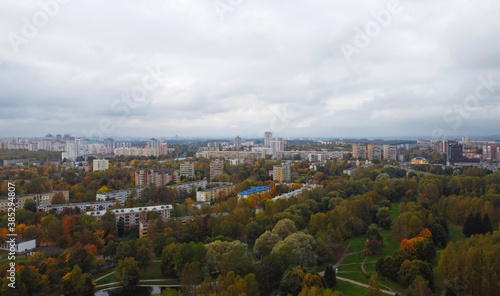 Top view of the autumn city near the park with trees