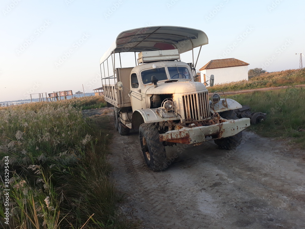 Ukraine, Kherson region, Dzharylgach island, September 15, 2020. Old rusty ZIL from the Soviet Union. Truck in the field.