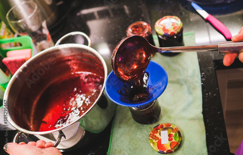 Senior woman prepare glasses with self made jam - Passion and natural food photo