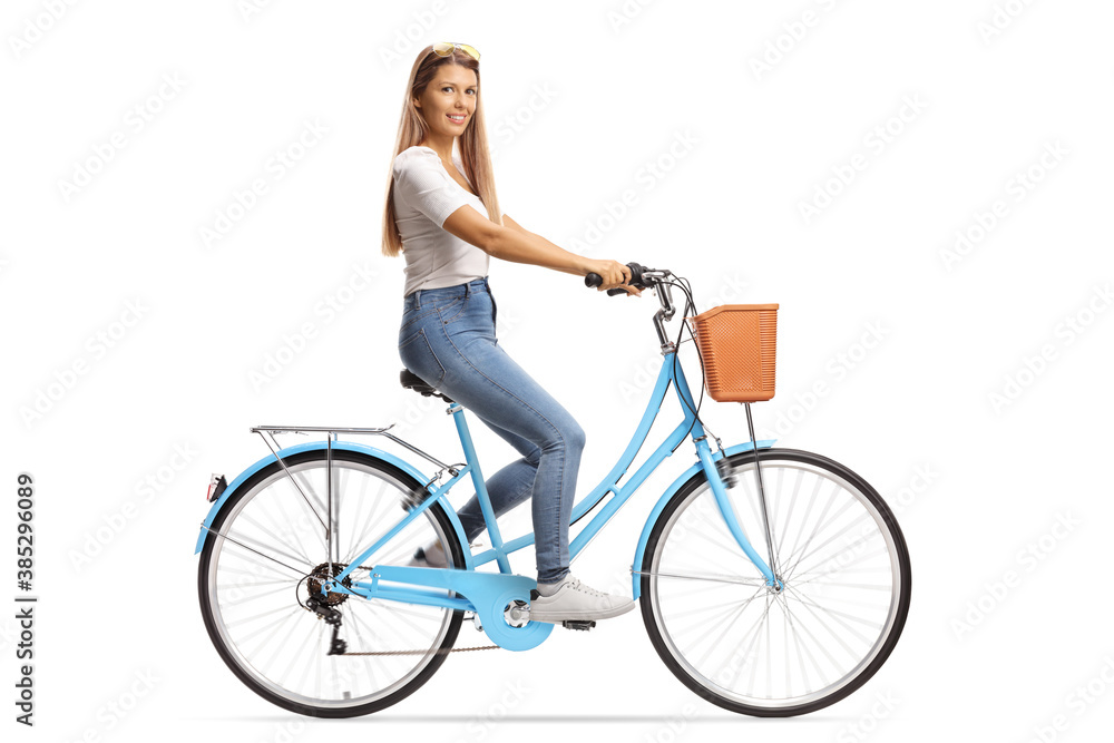Young female with long hair riding a bicycle and smiling at camera Young female with long hair riding a bicycle and smiling at camera