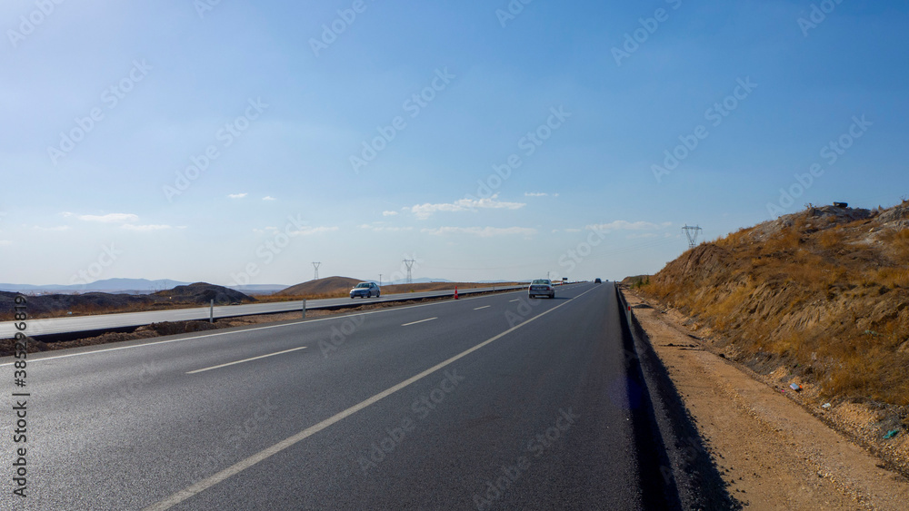 newly built asphalt road highway and vehicles long asphalt road,