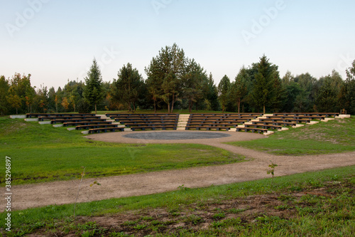 Empty seats at an outdoor amphitheater. Beautiful park scene and amphitheater for performances in the city park.