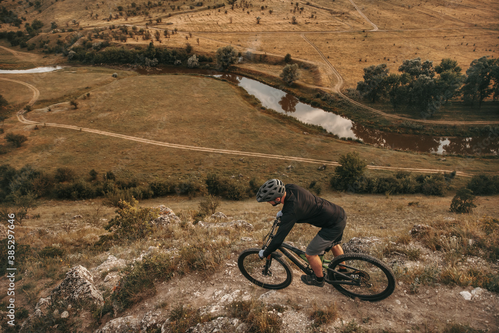 Unrecognizable man riding bike in mountains Unrecognizable man riding bike in mountains