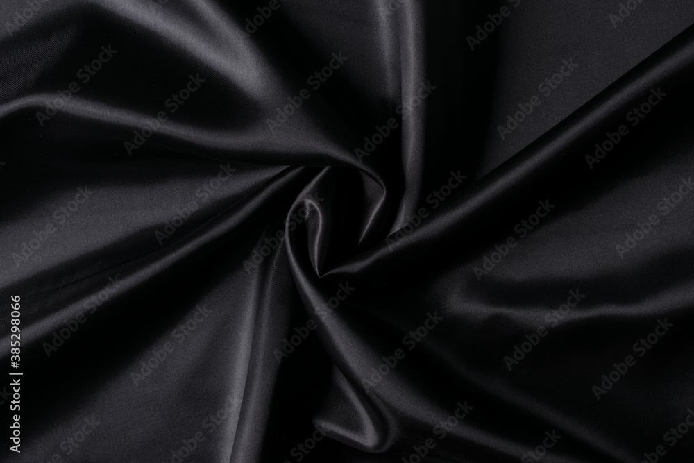 Luxurious black fabric background. Smooth elegant black silk or satin texture background.