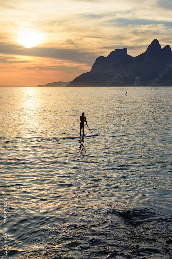 Stand up paddle at Arpoador beach in Ipanema during sunset