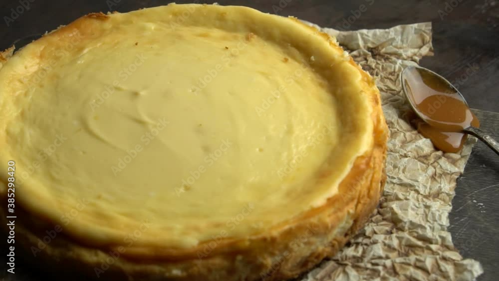 Blackboard cheesecake with caramel sauce. Smooth approach to the cake. Slow motion. Blackboard cheesecake with caramel sauce. Smooth approach to the cake. Slow motion.