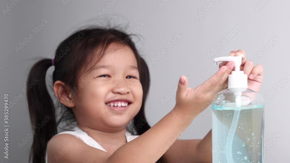Little child girl using hand sanitizer alcohol gel pump dispenser antibacterial antiseptic washing hand to prevent spreading virus, Selective focus and slow motion. Coronavirus COVID-19 Prevention Con Little child girl using hand sanitizer alcohol gel pump dispenser antibacterial antiseptic washing hand to prevent spreading virus, Selective focus and slow motion. Coronavirus COVID-19 Prevention Con