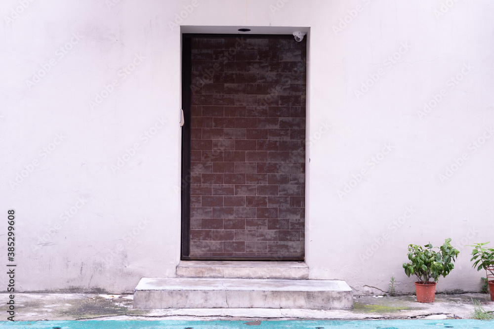 Fototapeta premium sidewalk by street wall & door