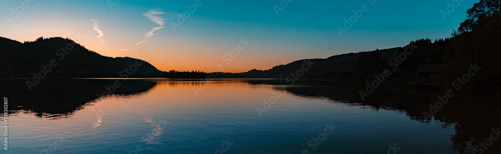 High resolution stitched panorama of a beautiful alpine sunset view with reflections at the famous Schliersee, Bavaria, Germany