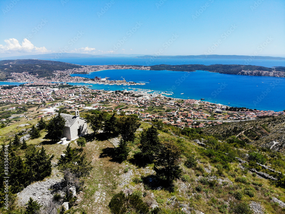 SEGET GORNJI, CROATIA - June 2020 - Aerial view of Sutilija hill. The church of St. Elijah church and Seget Valley and the Central Dalmatia Islands in distance.