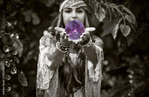 Gypsy woman fortune teller with a crystal ball, Concept of predictions, magic rituals photo