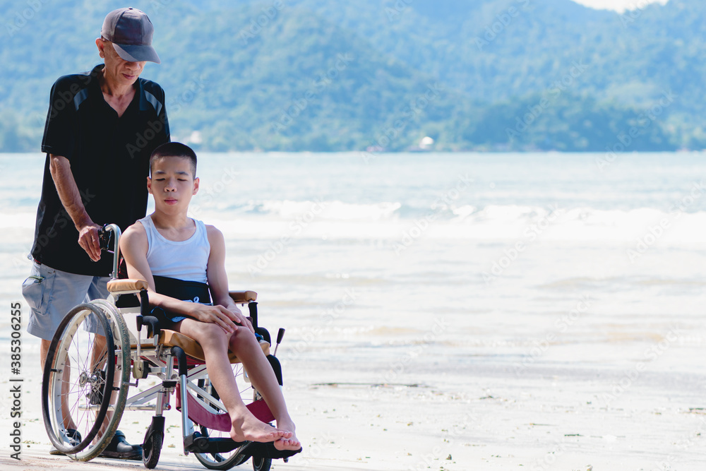 custom made wallpaper toronto digitalFather and Asian special child on wheelchair is smiling, playing do activity on the sea beach, Lifestyle of disability child, Life in the education age, Happy disabled kid in travel holidays concept.