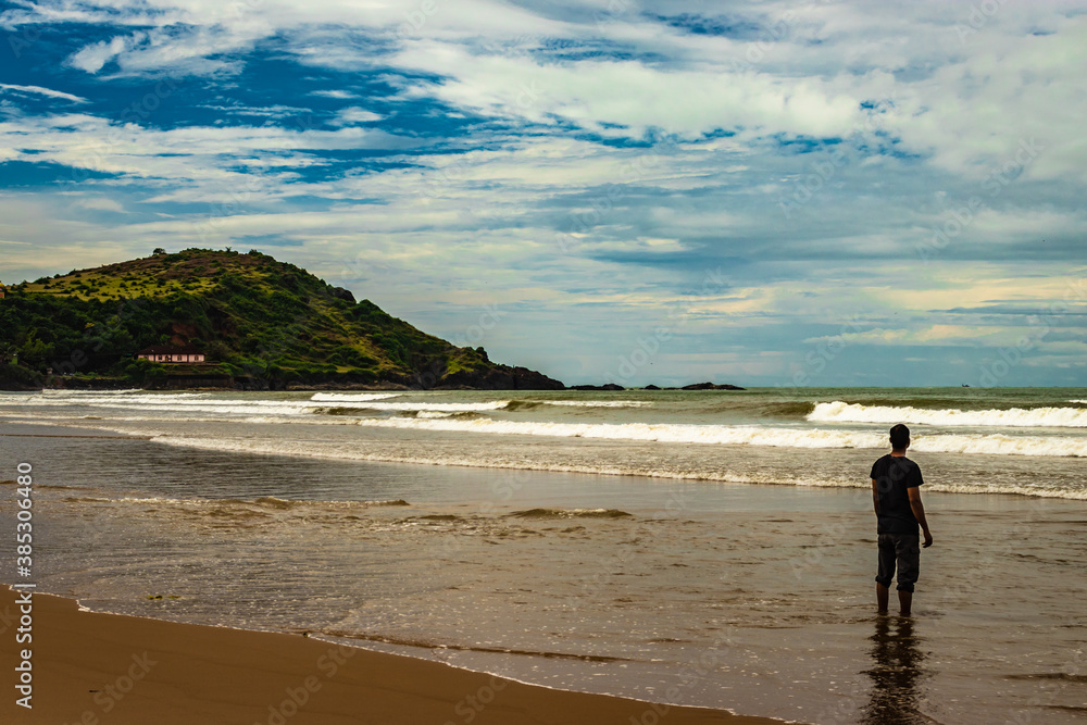 man watching the pristine sea view at morning from flat angle man watching the pristine sea view at morning from flat angle