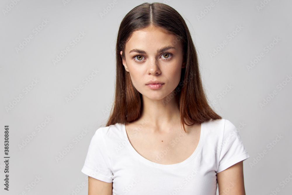 Portrait of a beautiful woman in a white t-shirt front view Portrait of a beautiful woman in a white t-shirt front view