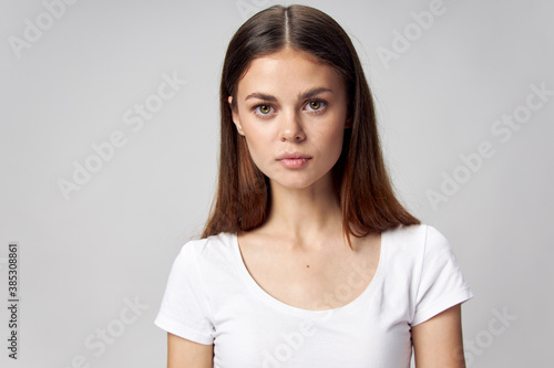Portrait of a beautiful woman in a white t-shirt front view 