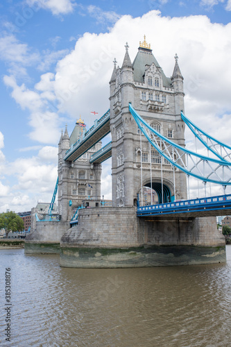 The Iconic Tower Bridge Over the River Thames and Under a Cloudy Blue Sky