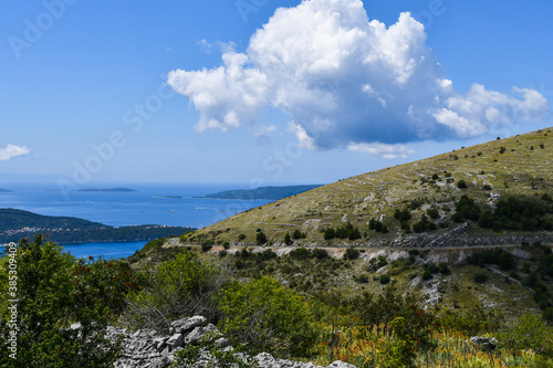 Mediterranean landscape. Hill slope and Adriatic sea in distance. Beautiful summer day in Trogir hinterland.