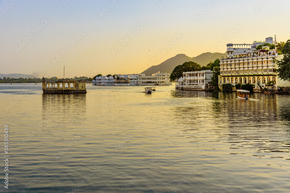 Panoramic sunset view of Udaipur city at Lake Pichola from Ambrai Ghat which is famous tourist vacation destination in Rajasthan, India.