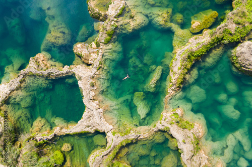 Aerial view of woman in swimsuit bathing in the El Salto waterfalls, Mexico. photo