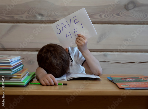 boy tired of doing home education at the table