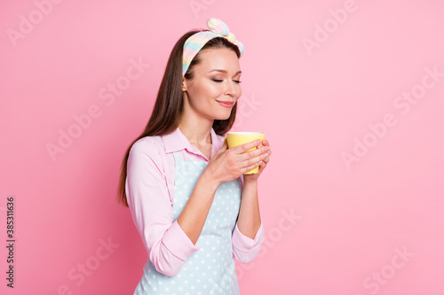 Portrait of positive cheerful girl wife hold caffeine beverage mug smell enjoy wear good look dotted clothes isolated over pastel color background