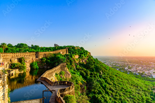 View during sunset from Chittor or Chittorgarh Fort with city in backdrop. It is one of the largest forts in India & listed in the UNESCO World Heritage Sites list as Hill Forts of Rajasthan.