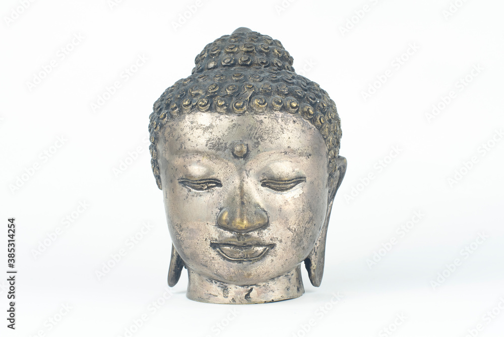 Isolated silver Buddah head statue