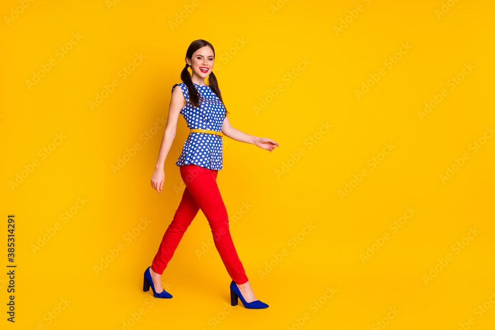 Full length body size view of her she nice attractive pretty lovely winsome classy chic slim fit cheerful cheery girl walking strolling isolated bright vivid shine vibrant yellow color background Full length body size view of her she nice attractive pretty lovely winsome classy chic slim fit cheerful cheery girl walking strolling isolated bright vivid shine vibrant yellow color background