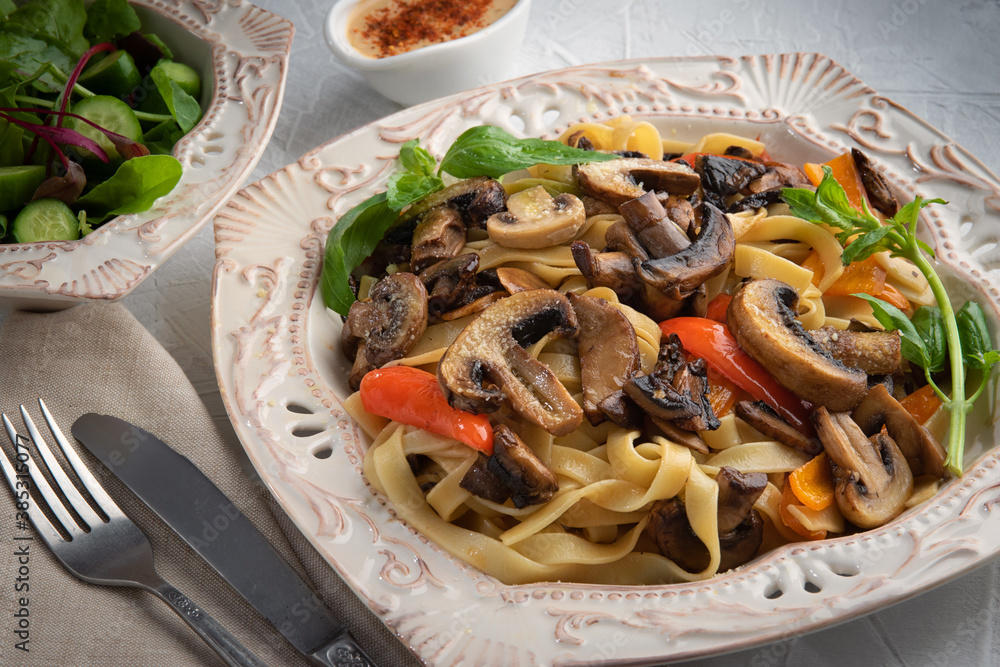 Pasta Fettuccine Bolognese with mushrooms and vegetables on white plate. Menu concept. Pasta Fettuccine Bolognese with mushrooms and vegetables on white plate. Menu concept.