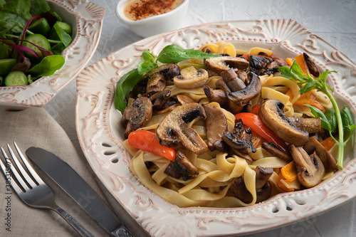 Pasta Fettuccine Bolognese with mushrooms and vegetables on white plate. Menu concept.