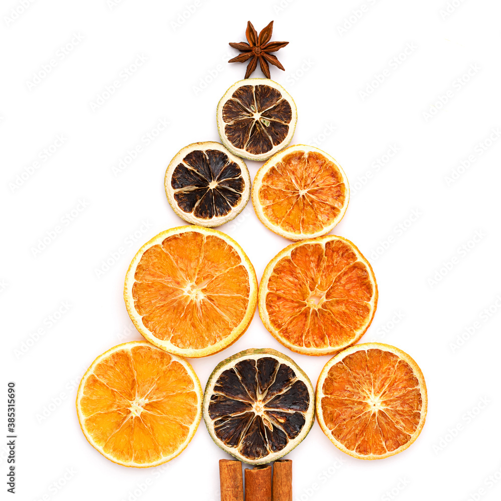 Christmas tree made of dried oranges and lime slices, cinnamon sticks and star anise. Square composition. Christmas tree made of dried oranges and lime slices, cinnamon sticks and star anise. Square composition.