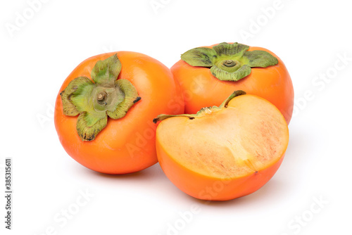Persimmon fruit with cut in half isolated on white background. clipping path.
