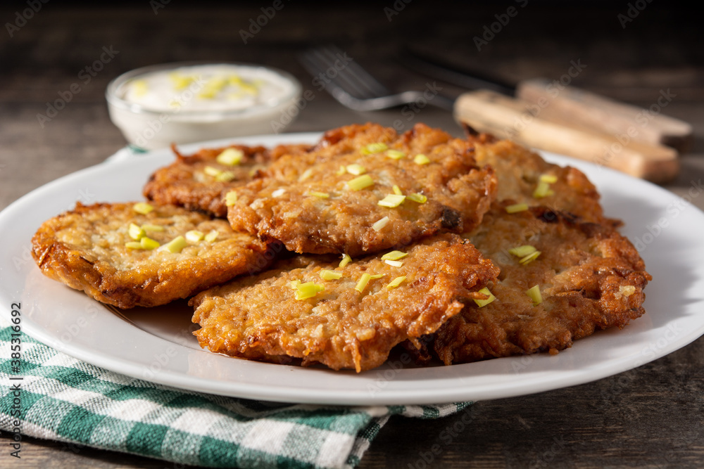 Traditional Jewish latkes or potato pancakes on wooden table