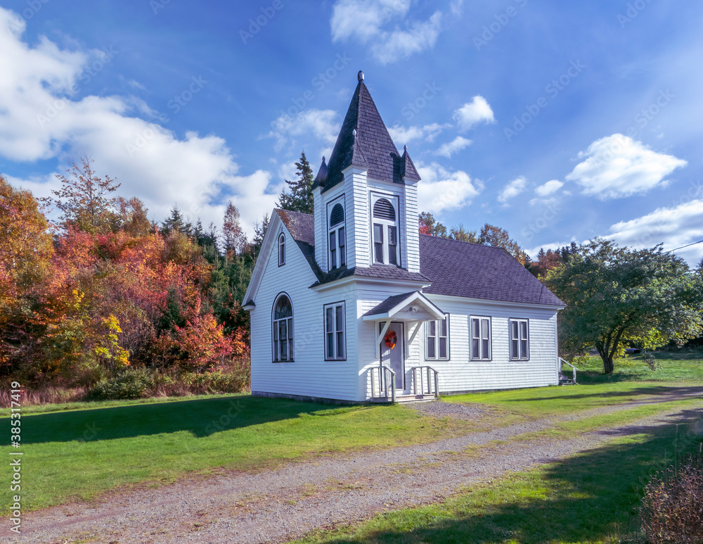 Rural church in autumn - The foliage of the trees surrounding the church in rural Nova Scotia are in autumn colors. Rural church in autumn - The foliage of the trees surrounding the church in rural Nova Scotia are in autumn colors.