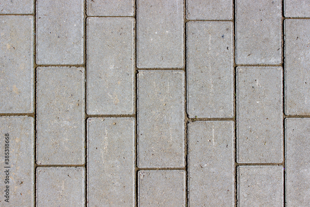 Fototapeta premium Clean newly layed grey rectangle pavement tiles background texture