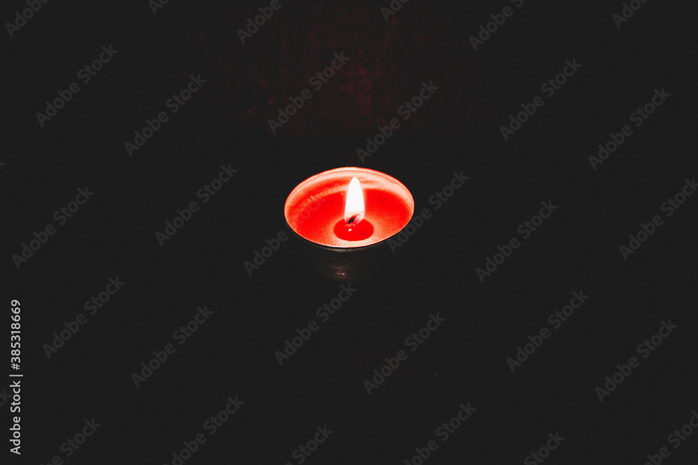candle burning against dark background candle burning against dark background