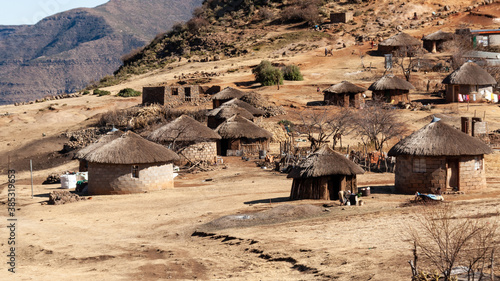 A village in Lesotho dominated by traditional round thatched roofed huts. Life in rural areas of the country is far from that of Western countries.
