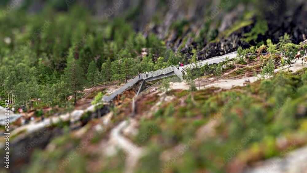 A aerial view of the bridge above the magnificent Voringsfossen waterfall in Hardangervidda national park, Norway. A spectacular bridge has a span of 47 meters. Many tourists are on the bridge