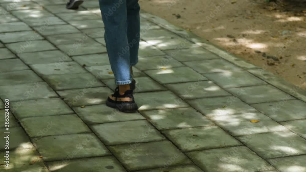 Close up of woman legs walking in shade on brick tiles at park in Pattaya, slow Close up of woman legs walking in shade on brick tiles at park in Pattaya, slow