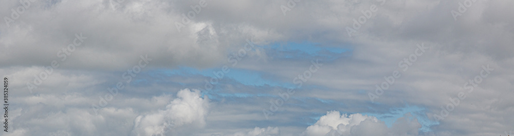 Image of a partly cloudy and partly clear sky during the day Image of a partly cloudy and partly clear sky during the day