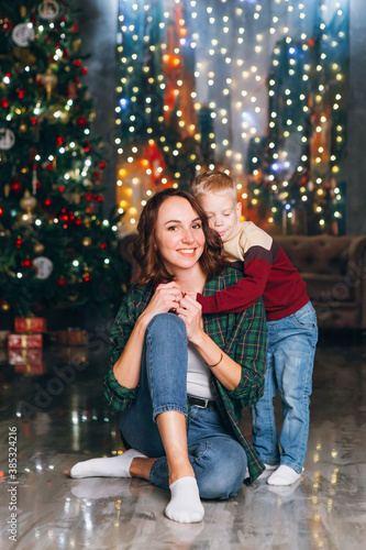Cute mom and little son blonde posing at the Christmas tree © irina_timokhina