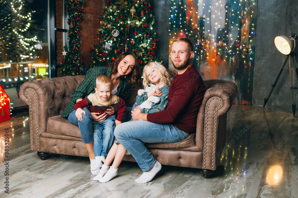 Young family with two children at the Christmas tree Young family with two children at the Christmas tree