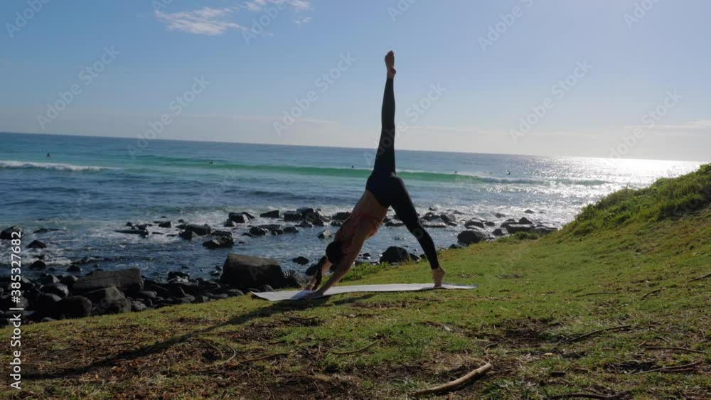 A Slim Woman Practicing Yoga At The Burleigh Beach ThreeLegged