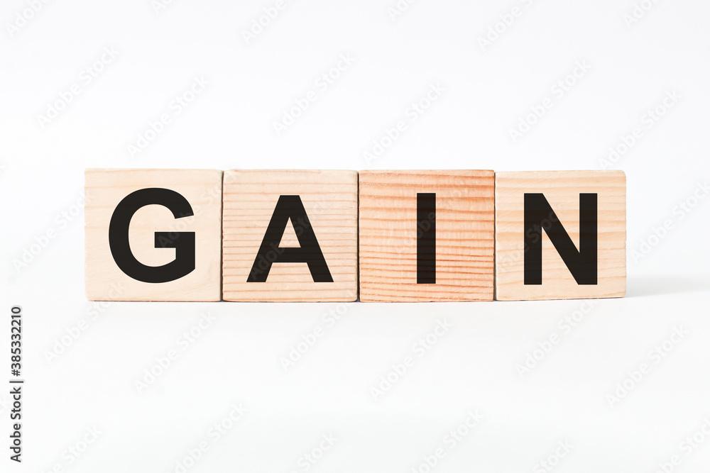 word GAIN on wooden blocks, white background, business concept. business and Finance word GAIN on wooden blocks, white background, business concept. business and Finance