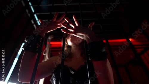 sexy lady is playing with cage for bdsm sex playing, closeup view of hands