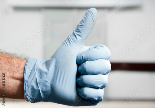 doctor hand doing ok at hospital operating room door