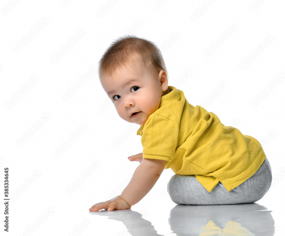 Little baby boy on floor looking over shoulder Little baby boy on floor looking over shoulder