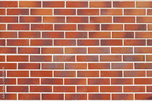 The wall is made of smooth brick. Brick wall, texture. Decorative brickwork in various shades