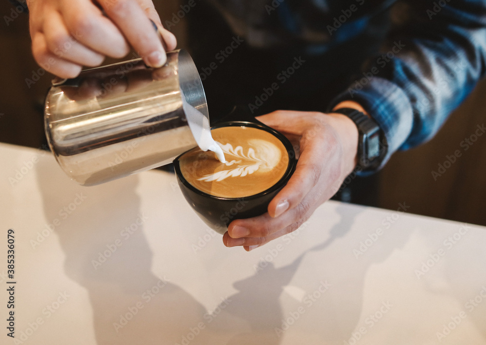 Barista pouring latte art